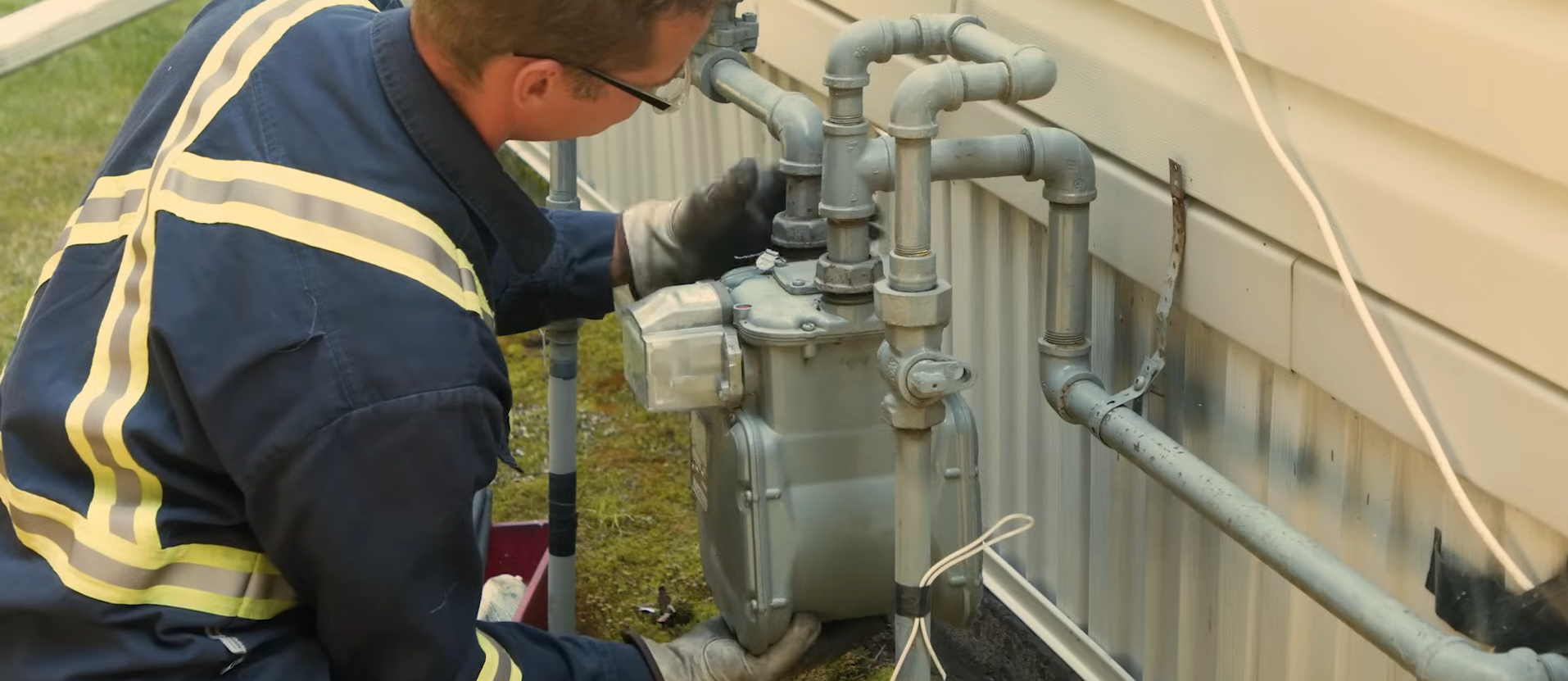 A Rocky Gas Co-op crew member inspecting a natural gas meter in the field.